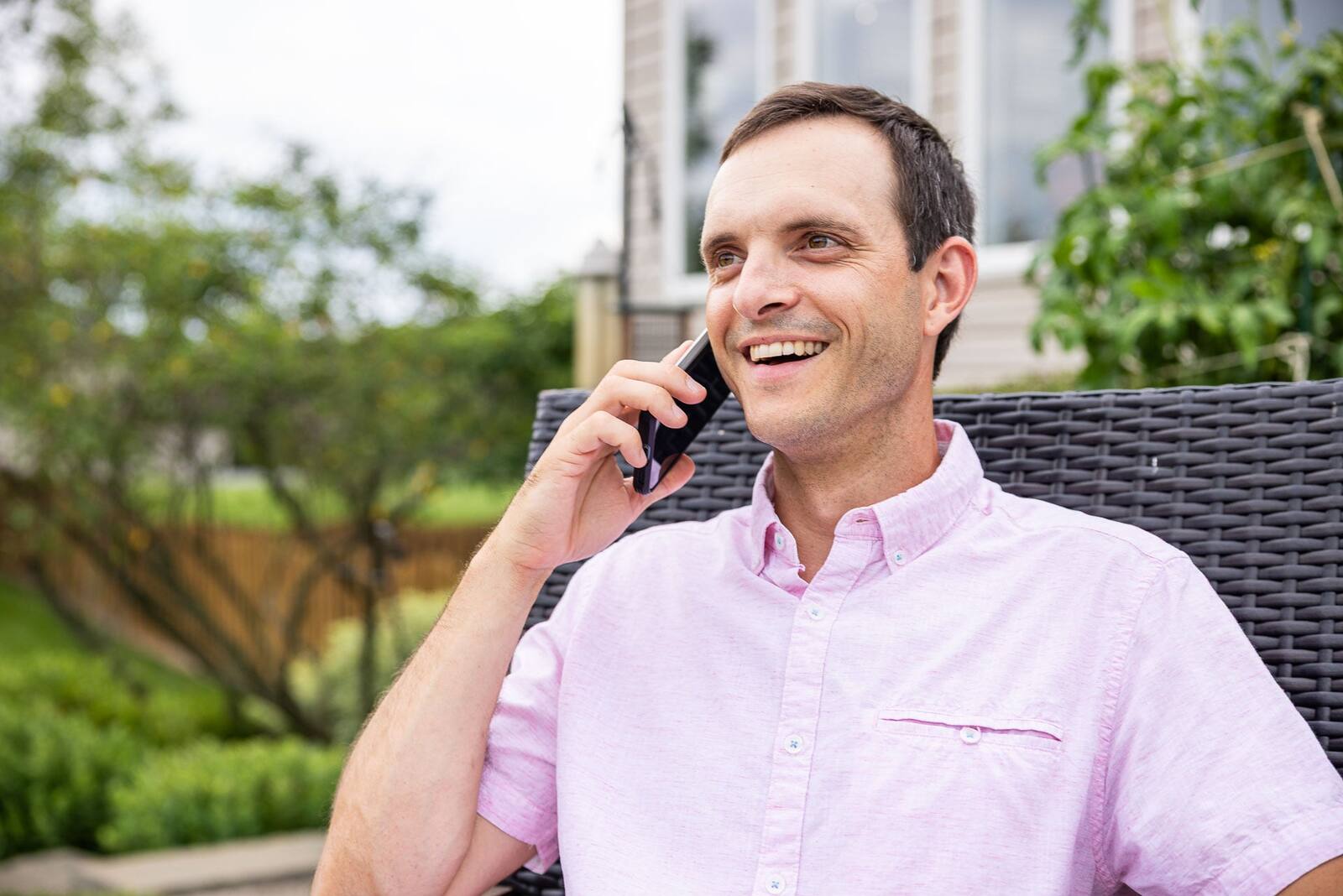 homeowner on the phone with tree care company