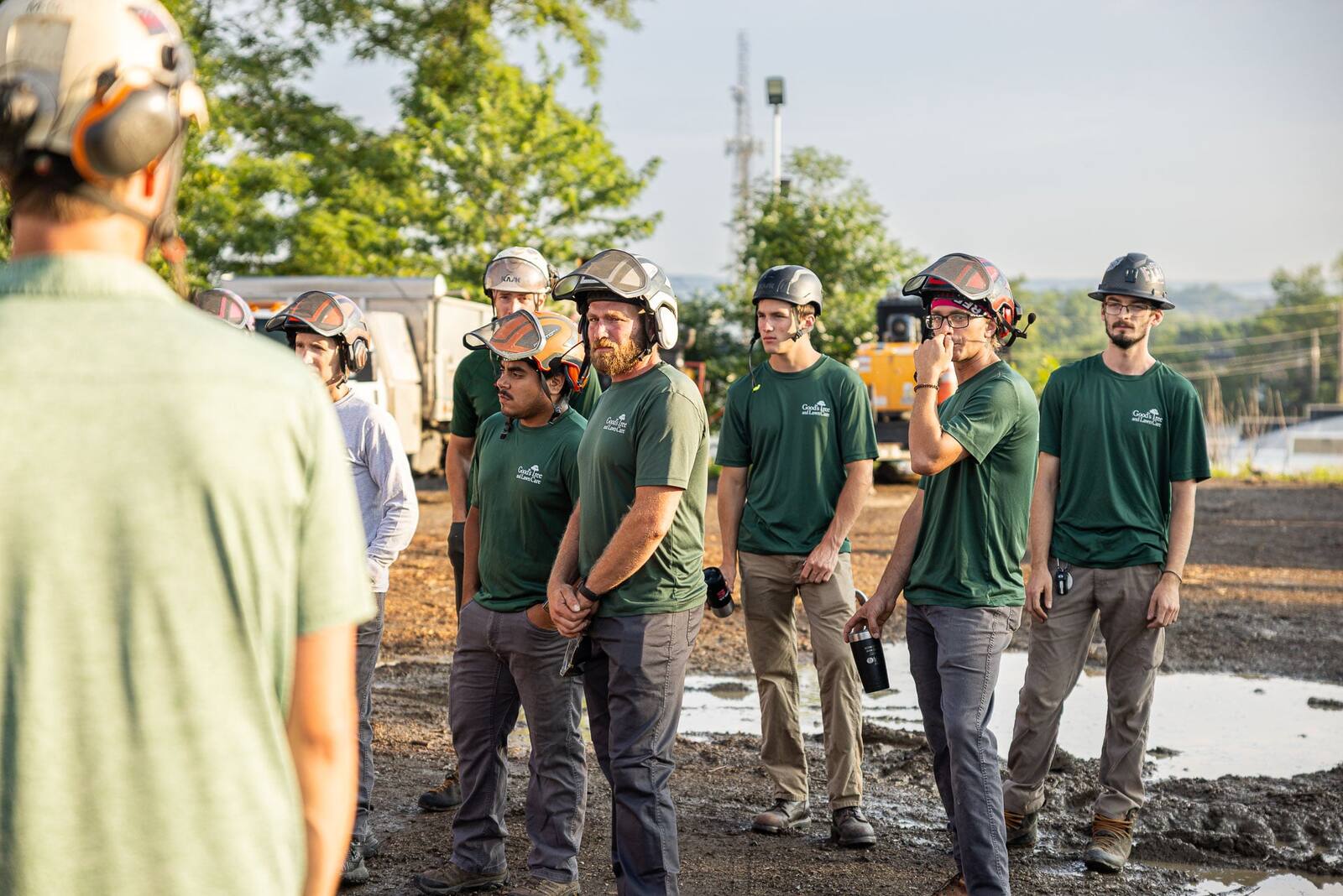 tree techs and lawn crew meeting in the yard