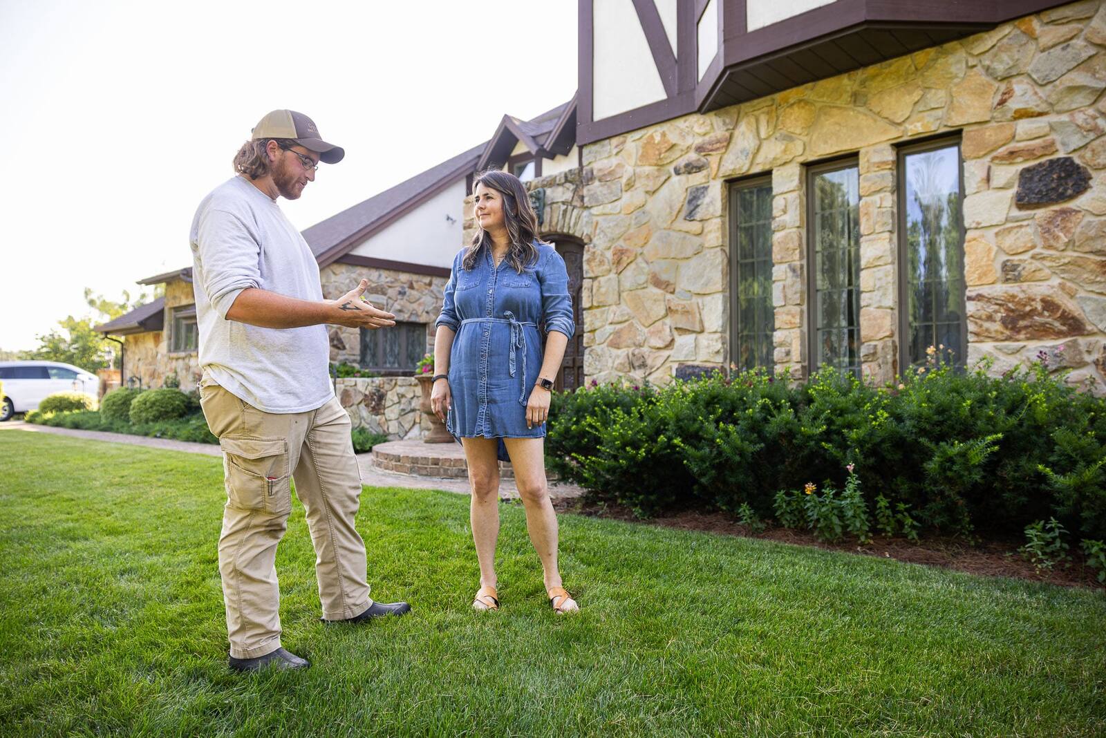 experience lawn care technician walking the property with a homeowner