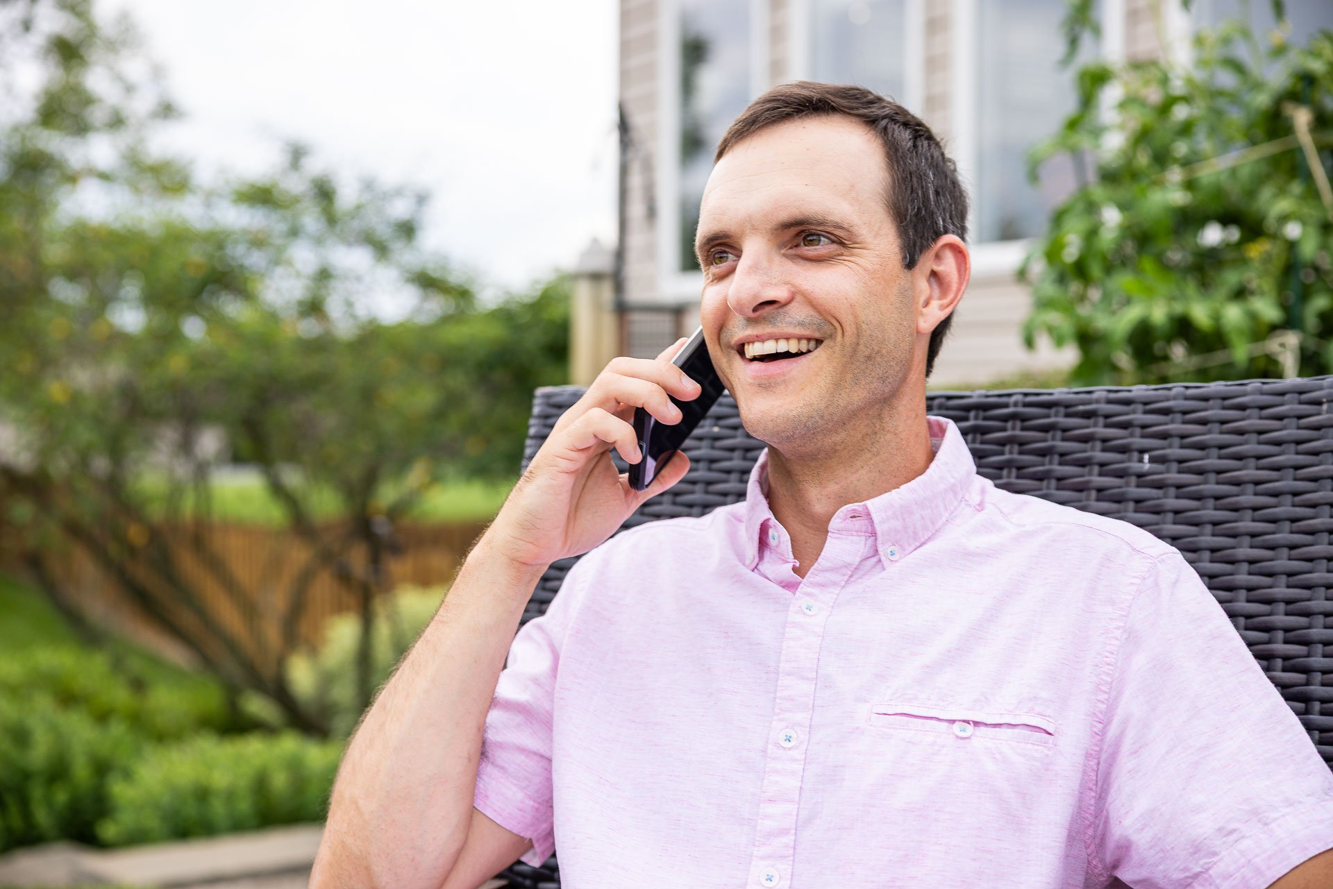homeowner on the phone with tree care company