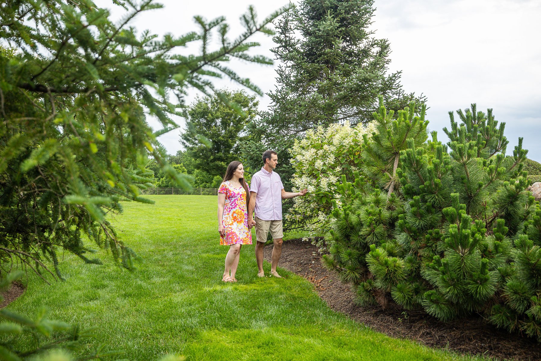 client walking yard inspecting plants shrubs flowers 2