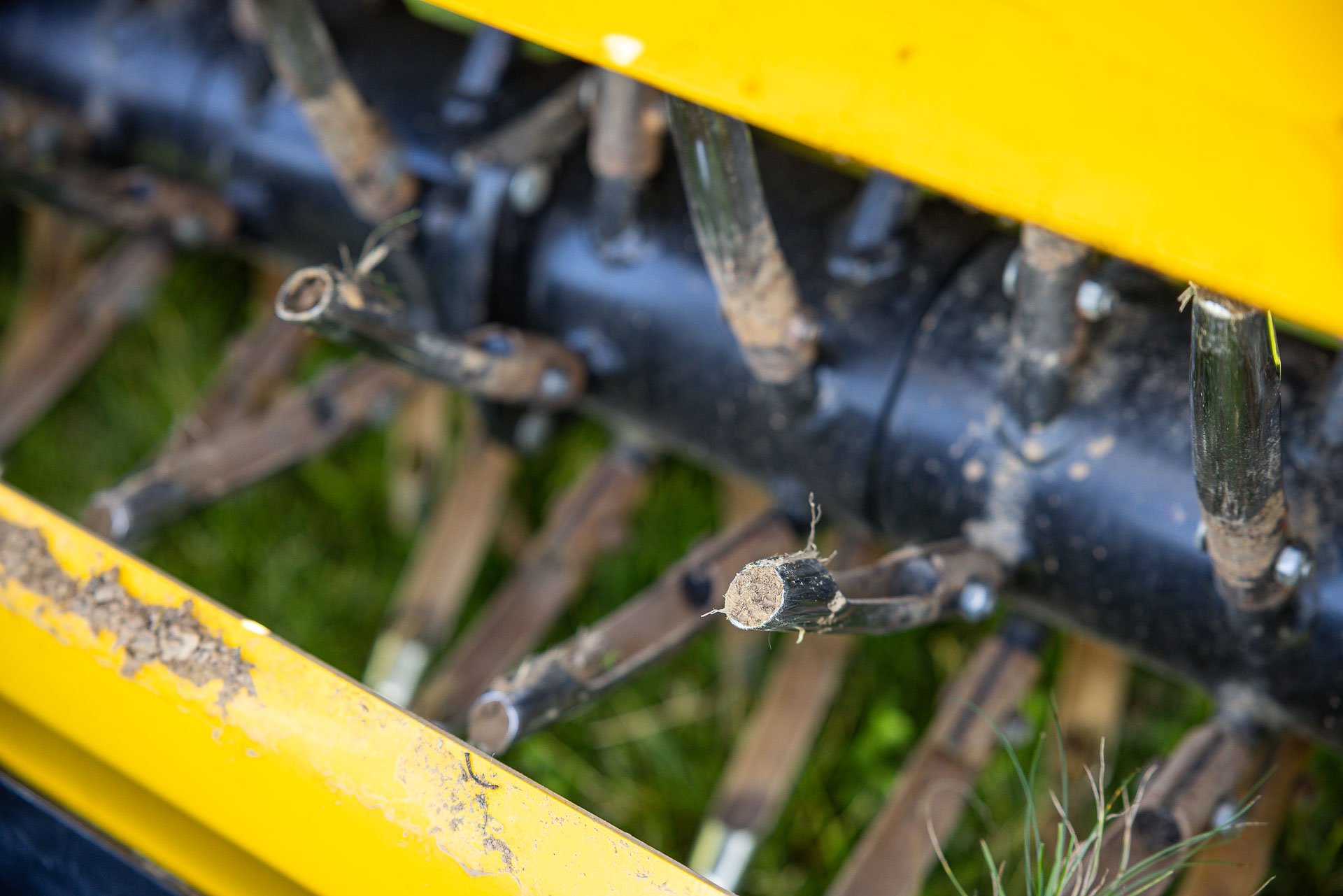 aeration tines pulling plugs of compacted soil