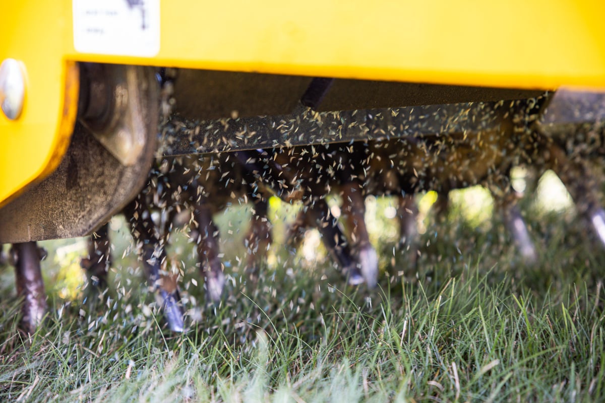a detailed look of an aeration and overseeding machine in action