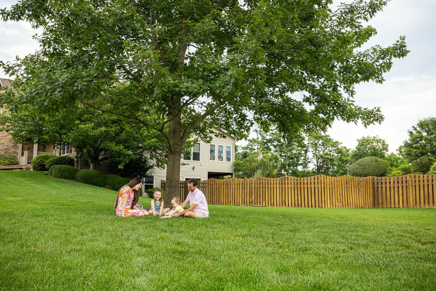 family parents kid client green lawn happy tree 5