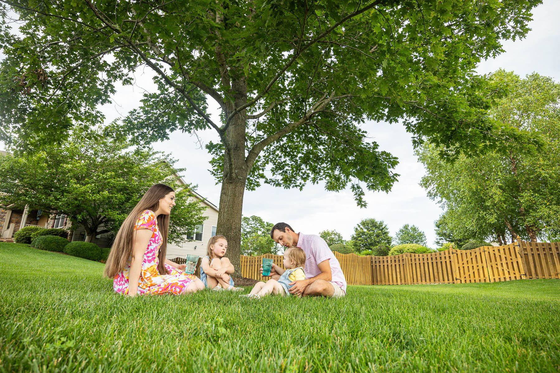 family enjoying healthy trees in their yard