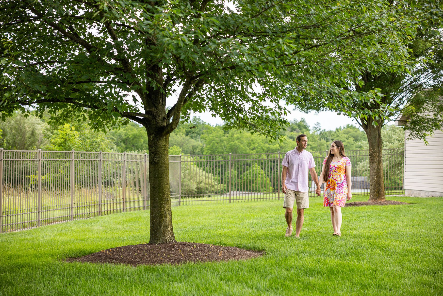 family walking enjoying green grass trees happy client 3