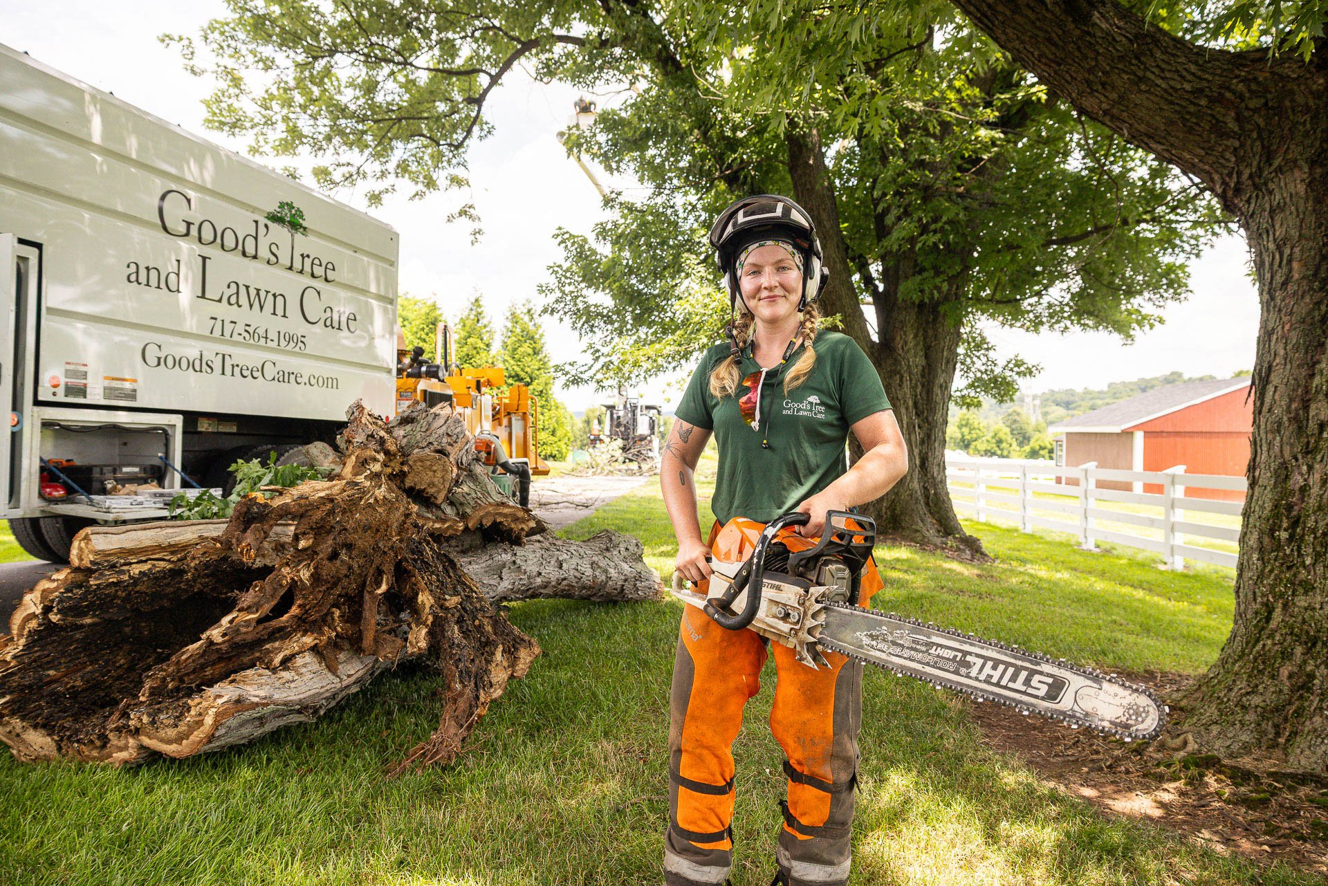 happy employee chainsaw tree removal woman goods