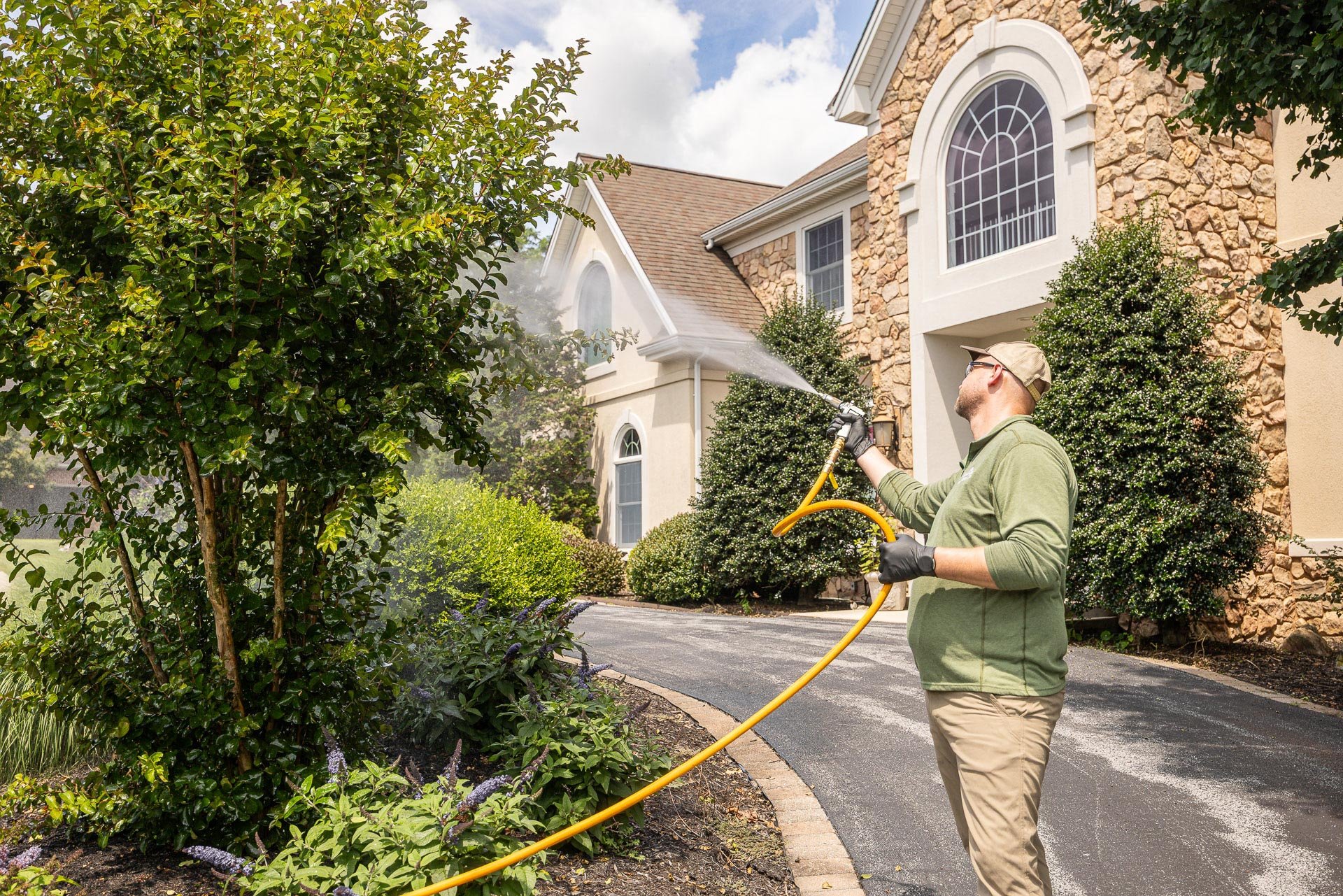 plant health care tech spraying shrubs trees 8