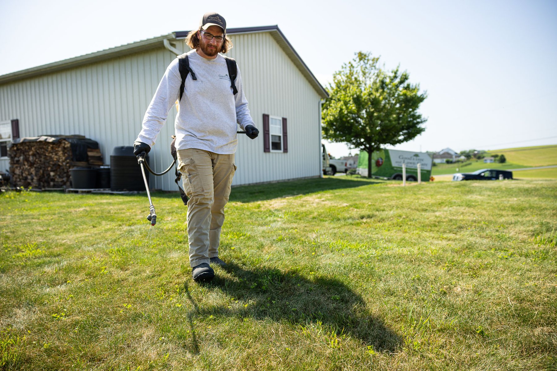 lawn care technician properly applying weed control