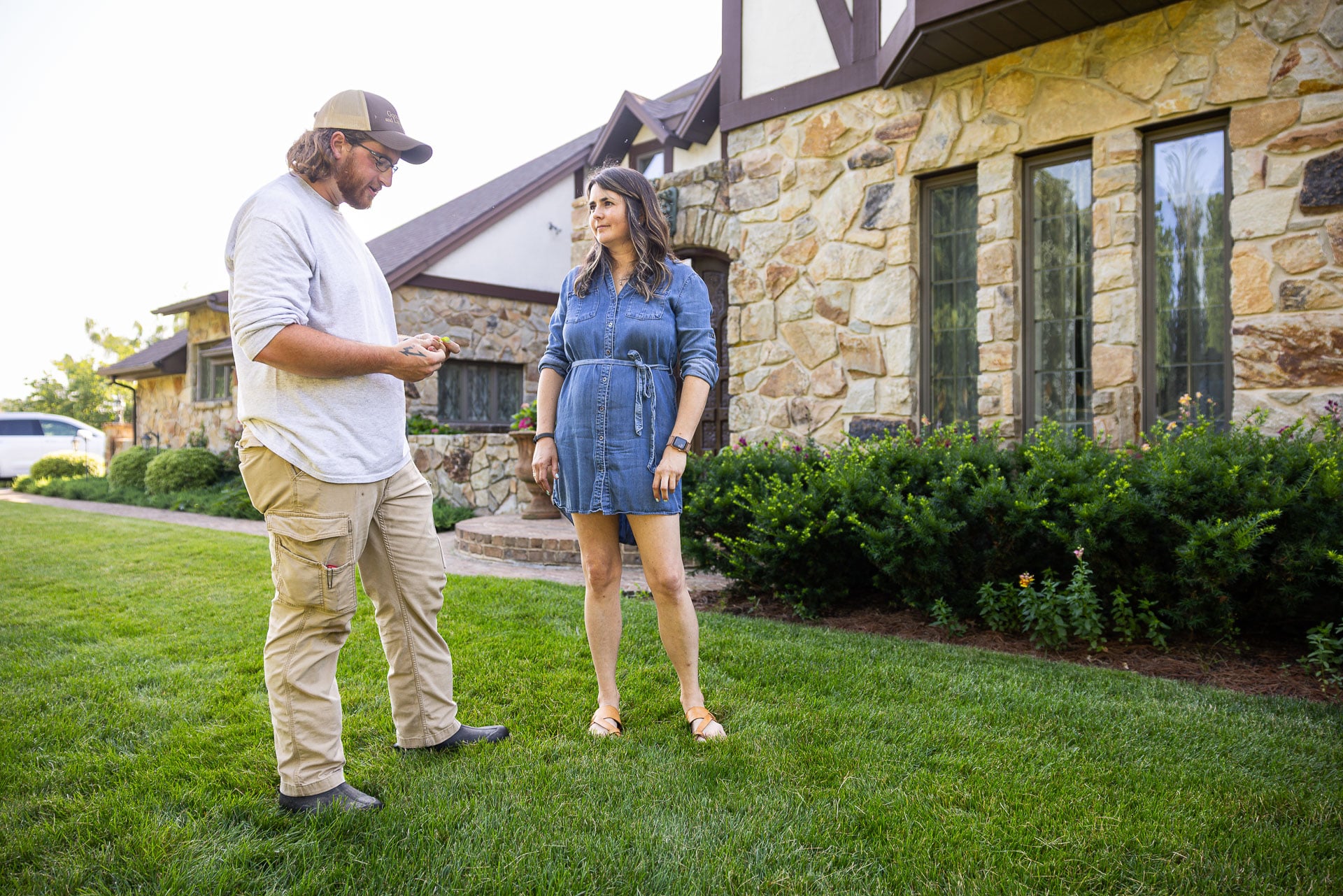 lawn care technician reviewing details with a homeowner